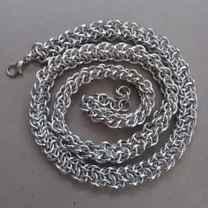 Bright silver aluminum chain mail necklace on a grey background.