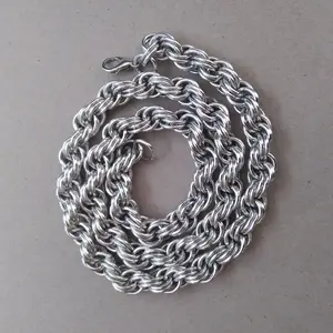 Bright silver aluminum chain mail necklace on a grey background.