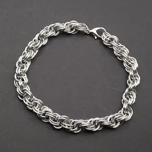 Bright silver aluminum chain mail bracelet on a dark grey background.